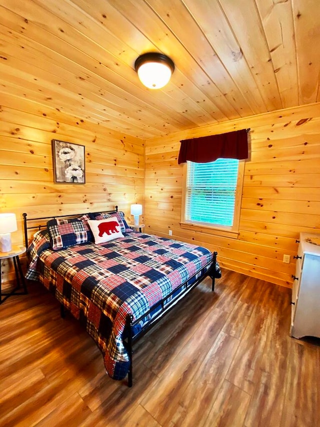 bedroom featuring wooden walls, dark hardwood / wood-style flooring, and wooden ceiling