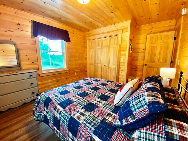 bedroom featuring dark wood-type flooring, wood ceiling, wooden walls, and a closet