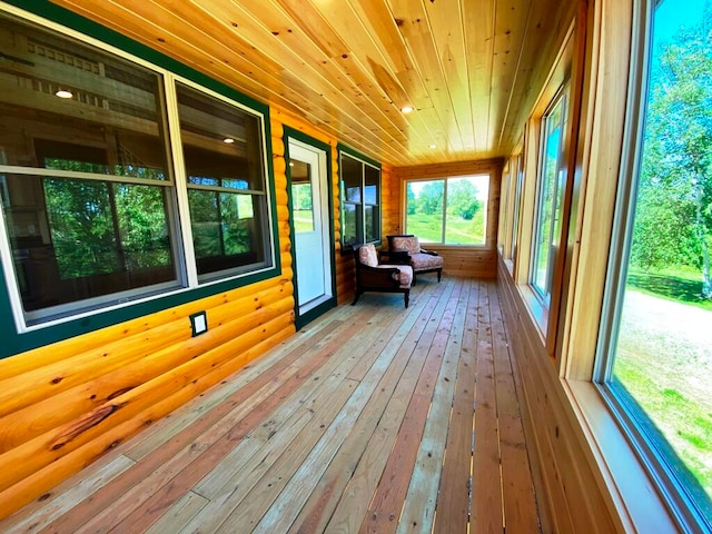 unfurnished sunroom featuring wooden ceiling