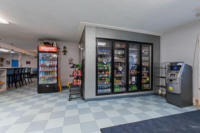 misc room featuring tile patterned floors and a textured ceiling