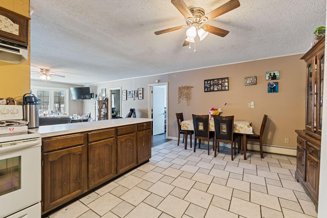 kitchen with white electric range oven, a textured ceiling, light countertops, a ceiling fan, and a baseboard heating unit