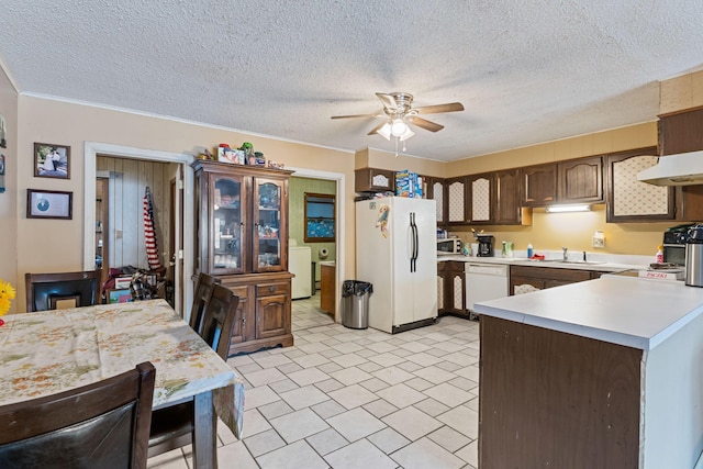 kitchen featuring light countertops, white appliances, a sink, washer / dryer, and a ceiling fan