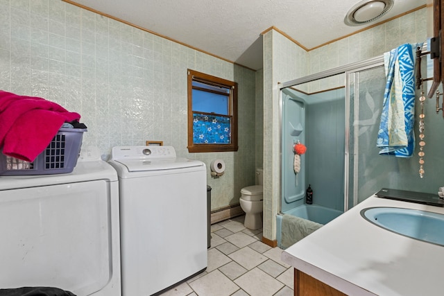 washroom with separate washer and dryer, a textured ceiling, baseboard heating, laundry area, and light tile patterned floors