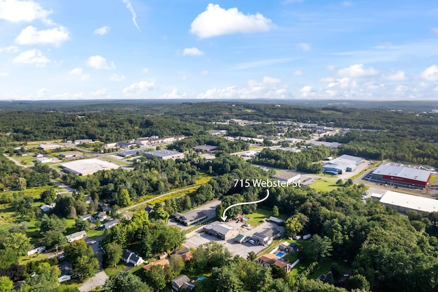 drone / aerial view with a wooded view