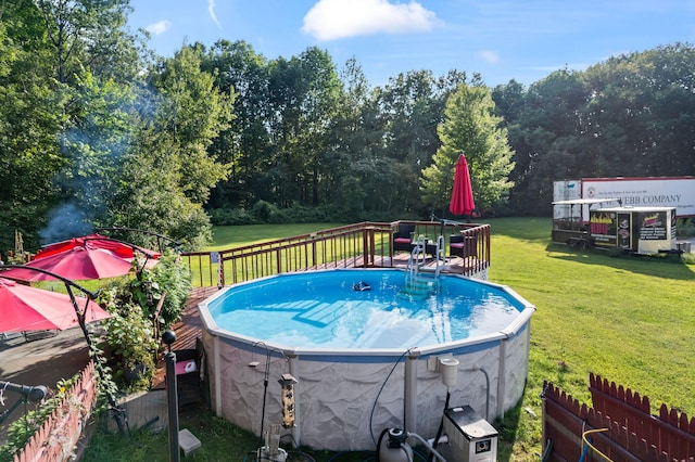 view of pool featuring a lawn