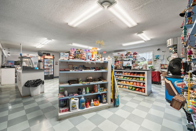 miscellaneous room featuring a textured ceiling and light floors
