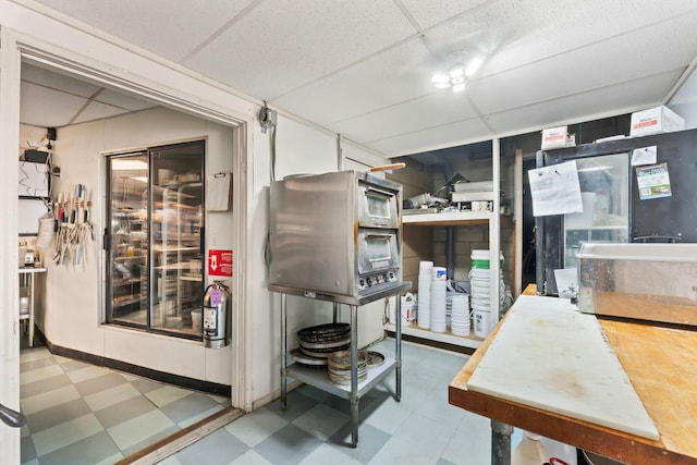 interior space featuring a drop ceiling and tile patterned floors