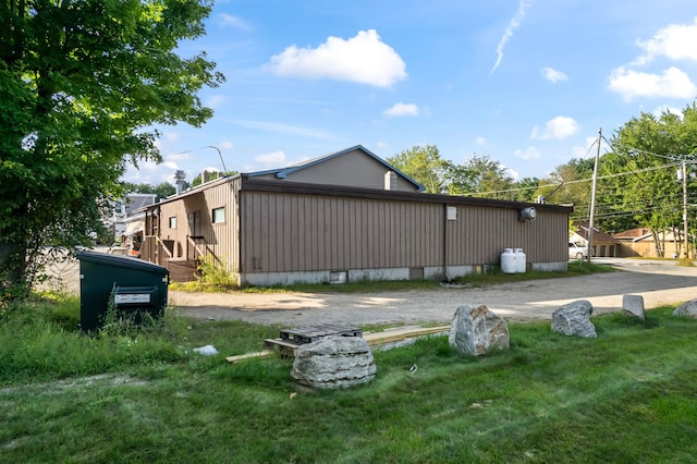 exterior space featuring a lawn, driveway, and crawl space