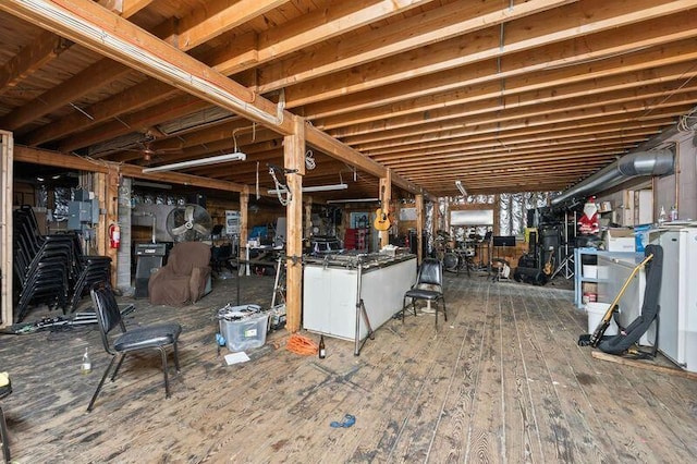 below grade area with electric panel and wood finished floors
