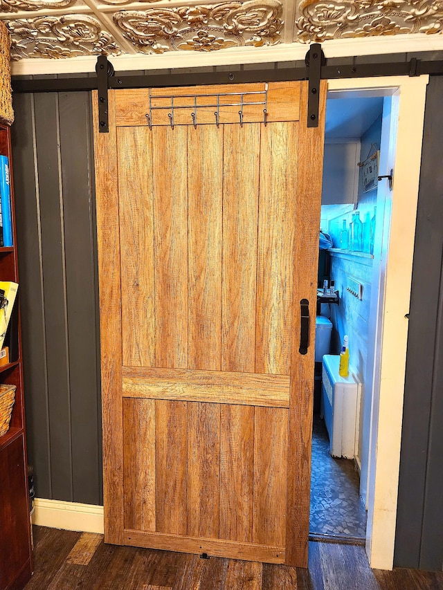 details with a barn door and hardwood / wood-style floors