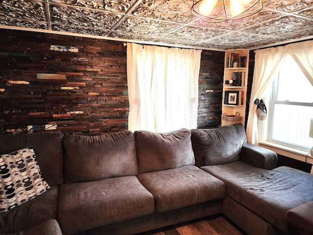 living room with wooden walls and wood-type flooring