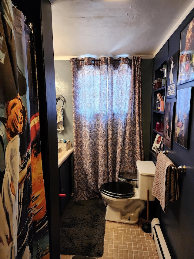 bathroom with vanity, toilet, tile patterned flooring, and a baseboard radiator