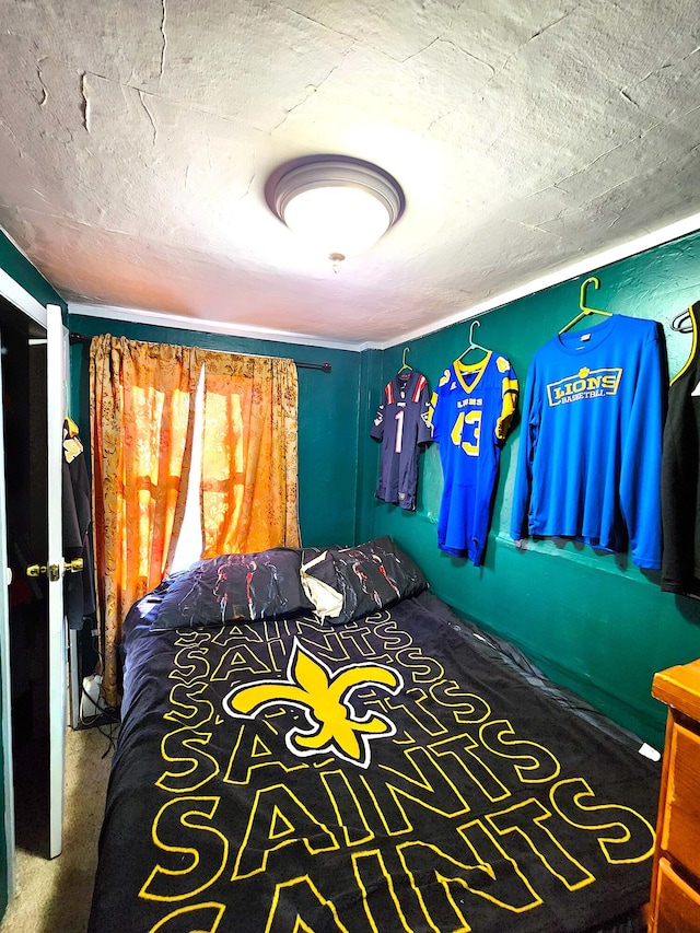 unfurnished bedroom featuring a textured ceiling and carpet floors