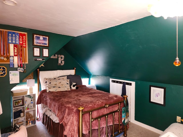 carpeted bedroom with vaulted ceiling