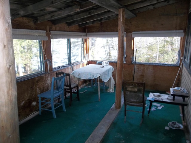 sunroom / solarium featuring lofted ceiling and a wealth of natural light