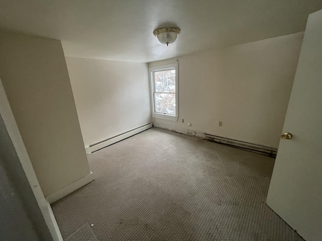 carpeted empty room featuring a baseboard radiator
