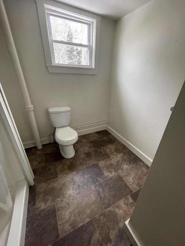 bathroom featuring toilet and tile flooring