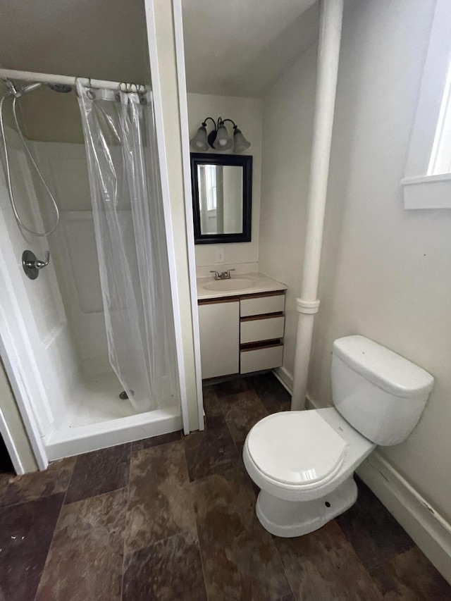 bathroom featuring walk in shower, tile flooring, toilet, and vanity