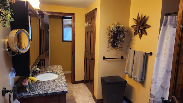 bathroom with tile floors and vanity