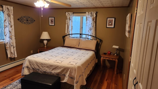 bedroom with wood-type flooring, ceiling fan, and crown molding