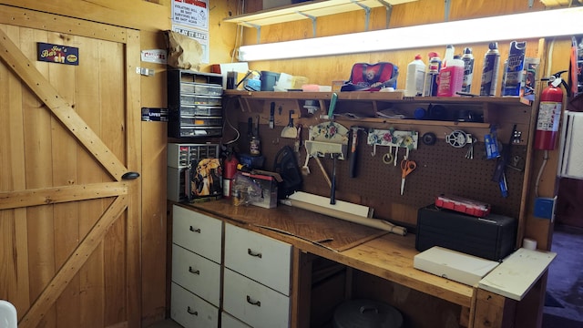 interior space featuring wooden walls and a workshop area