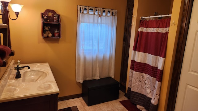 bathroom with tile flooring and vanity