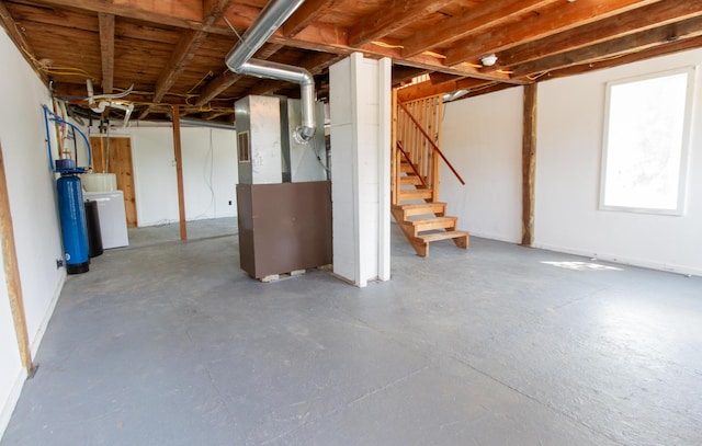 basement featuring washer / dryer and heating unit