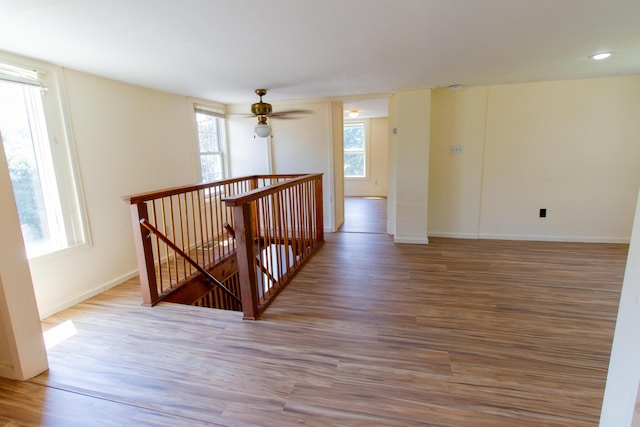 empty room with wood-type flooring and ceiling fan