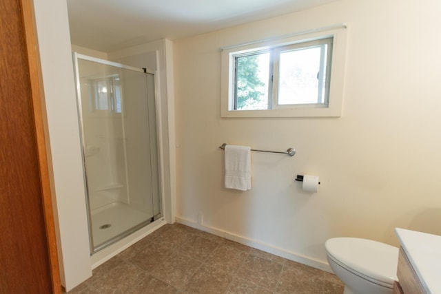 bathroom with vanity, a shower with shower door, and toilet