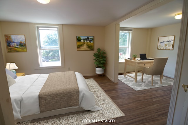 bedroom with dark hardwood / wood-style flooring