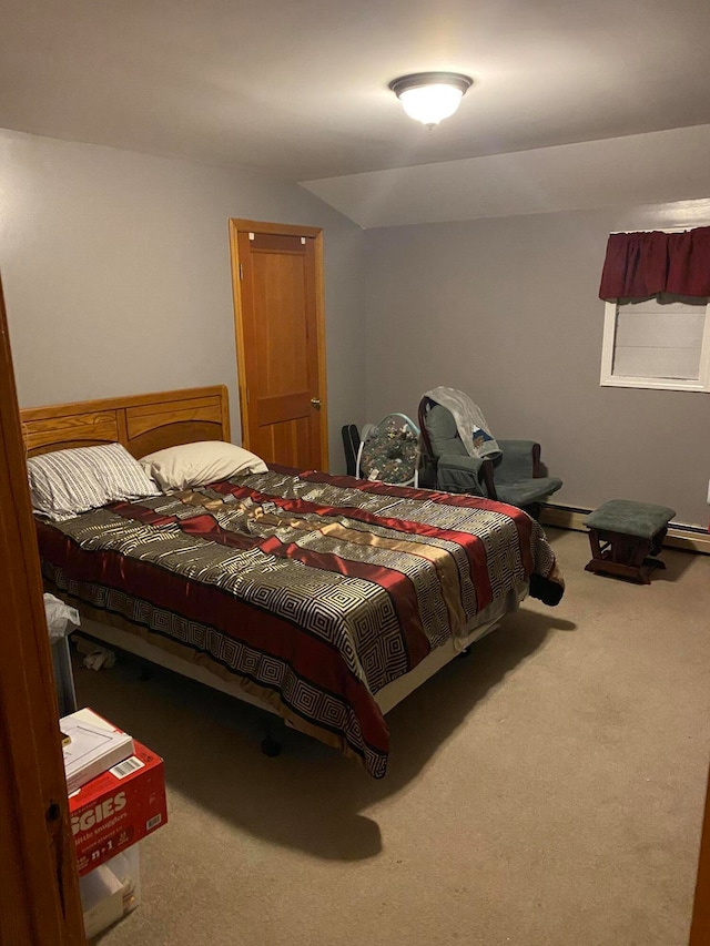 carpeted bedroom with a baseboard heating unit and vaulted ceiling