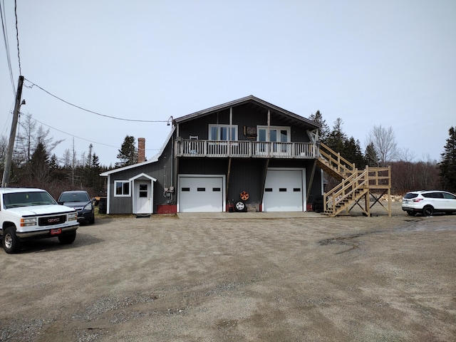 view of property with a balcony and a garage