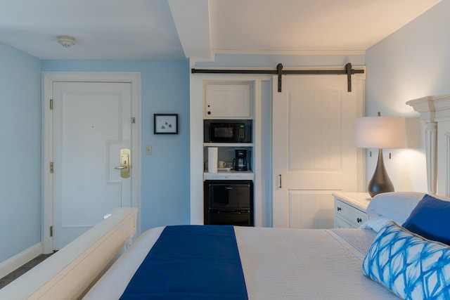 carpeted bedroom featuring a barn door