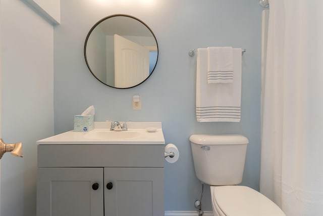 bathroom featuring toilet and vanity