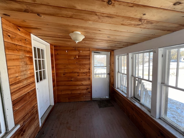 unfurnished sunroom featuring wooden ceiling and plenty of natural light