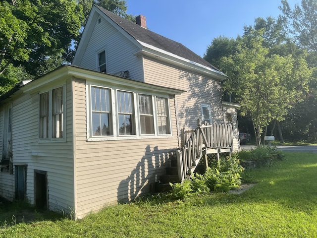 view of property exterior featuring a lawn