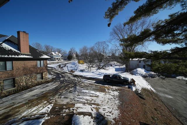 yard covered in snow with a garage