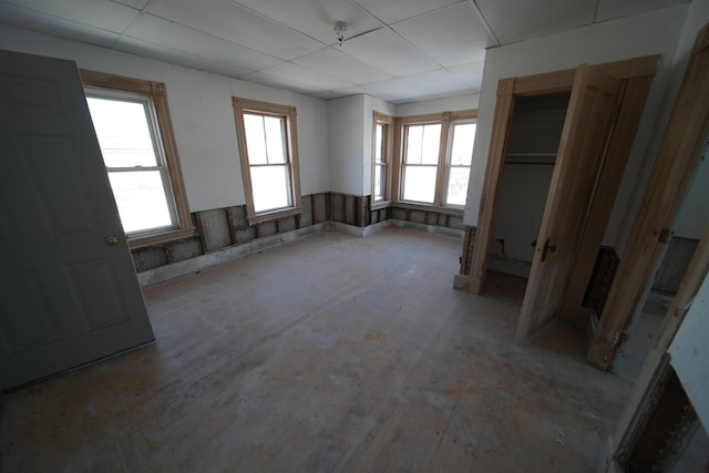 unfurnished bedroom featuring a closet and a drop ceiling