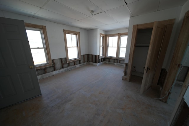 unfurnished bedroom featuring a drop ceiling