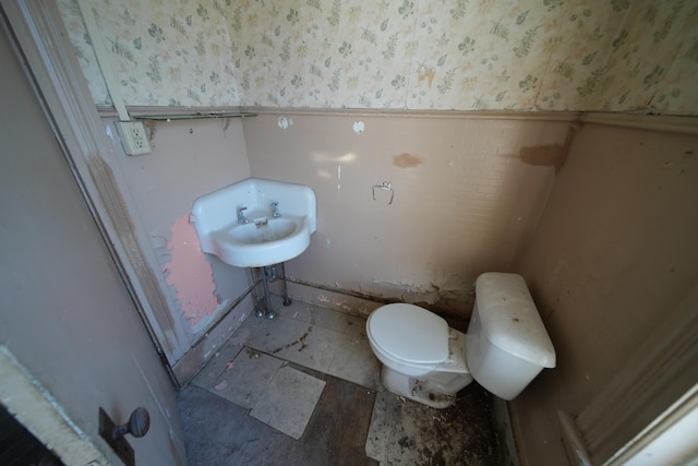 bathroom featuring sink, toilet, and tile floors