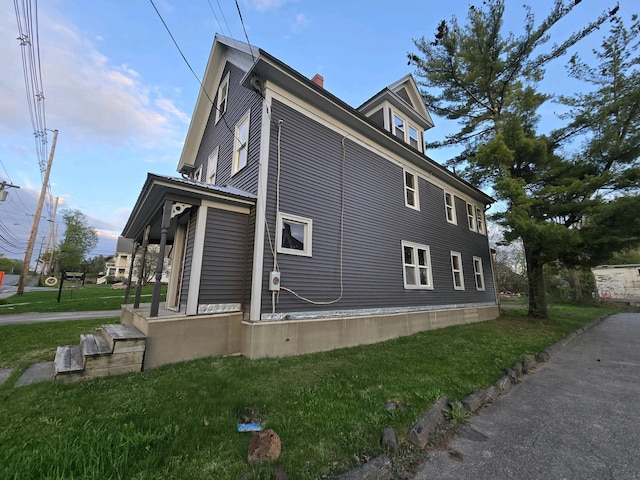 view of side of property with a lawn