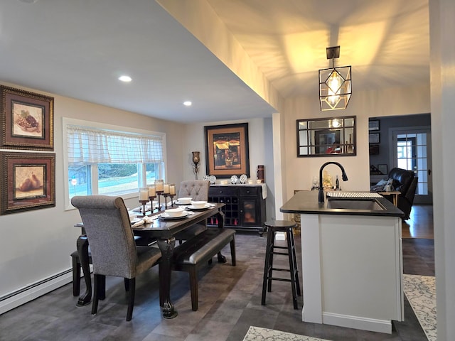 dining room with dark hardwood / wood-style floors, baseboard heating, and sink