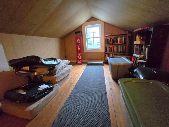 bonus room featuring wooden ceiling, vaulted ceiling, light hardwood / wood-style flooring, and wooden walls