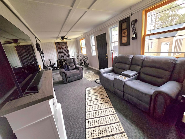 living room with ceiling fan, crown molding, and carpet flooring