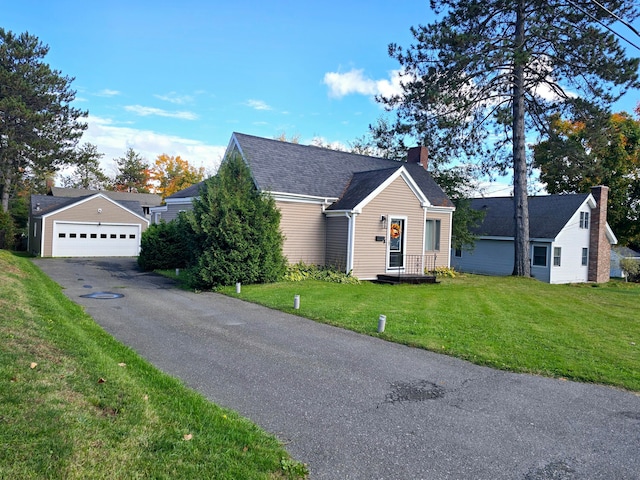 view of front of home featuring a garage and a front lawn