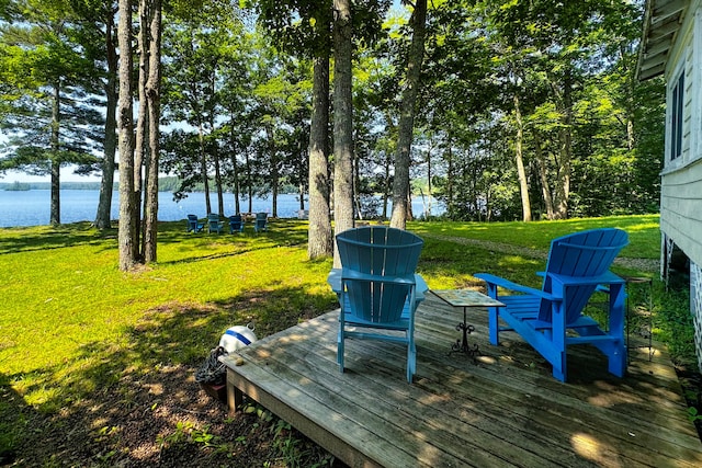 wooden deck featuring a lawn and a water view