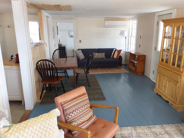 living room featuring plenty of natural light, a wall mounted AC, and dark hardwood / wood-style flooring