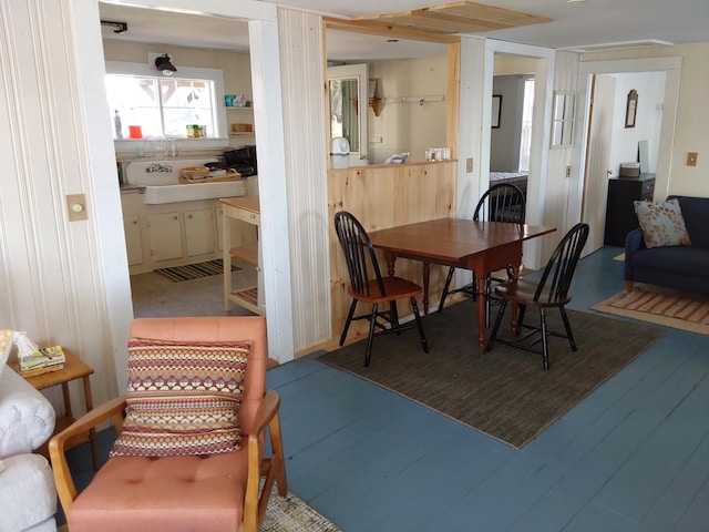 dining room featuring wood-type flooring and sink