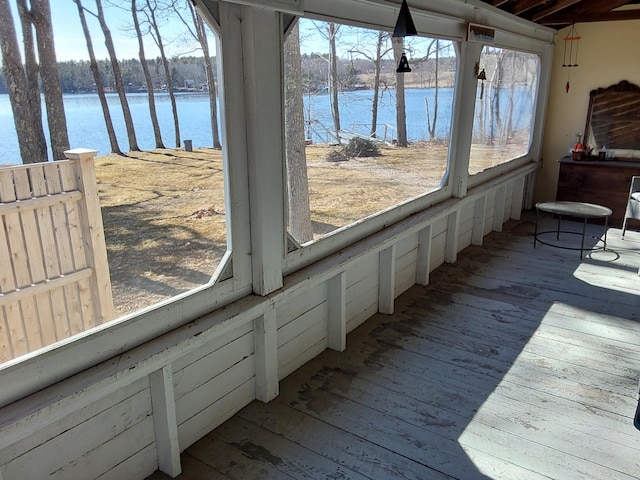 sunroom / solarium with a water view