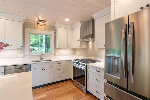862 W Neck Rd, Nobleboro, ME 04555 - kitchen featuring stainless steel appliances, wall chimney exhaust hood, light countertops, white cabinets, and light wood finished floors